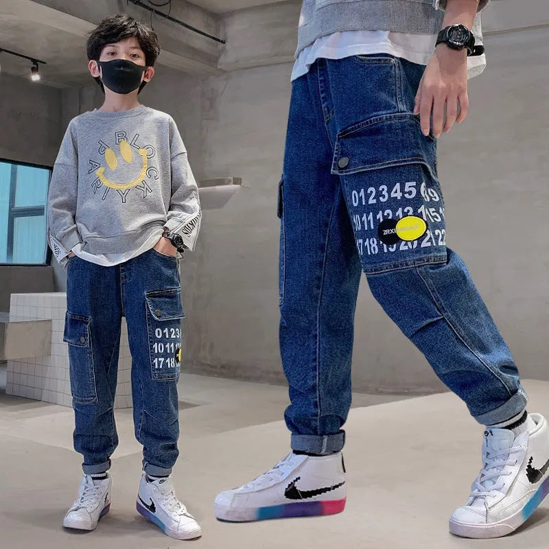 Boys printed blue cotton mid-waist girdled jeans with rubber band belt on white background