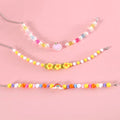 Colourful plastic bead pet necklace in peach, rainbow, and small flower designs for cats and dogs