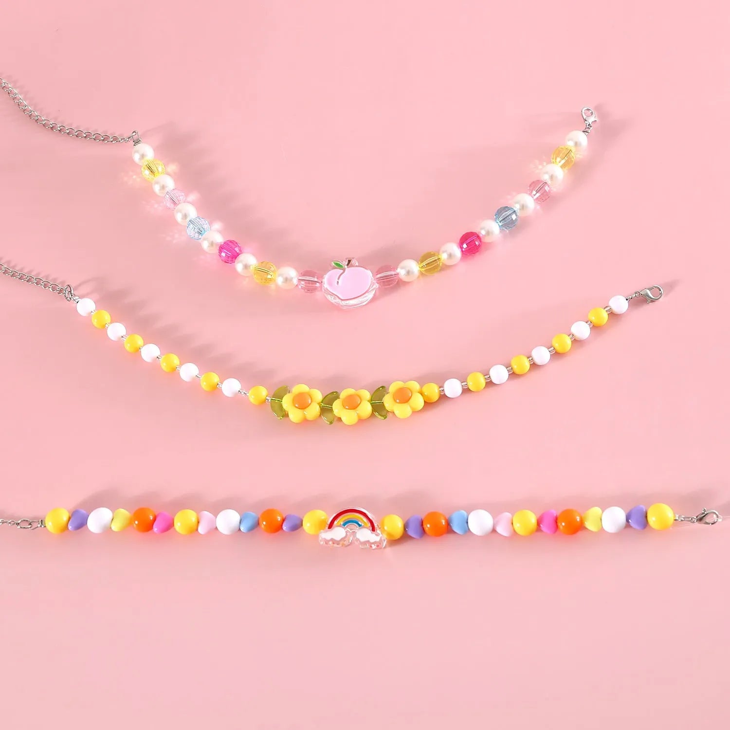 Colourful plastic bead pet necklace in peach, rainbow, and small flower designs for cats and dogs