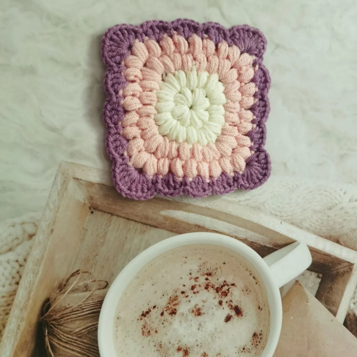 Handmade crocheted wool coaster with Grandmother Lattice pattern in Dream Purple colour.