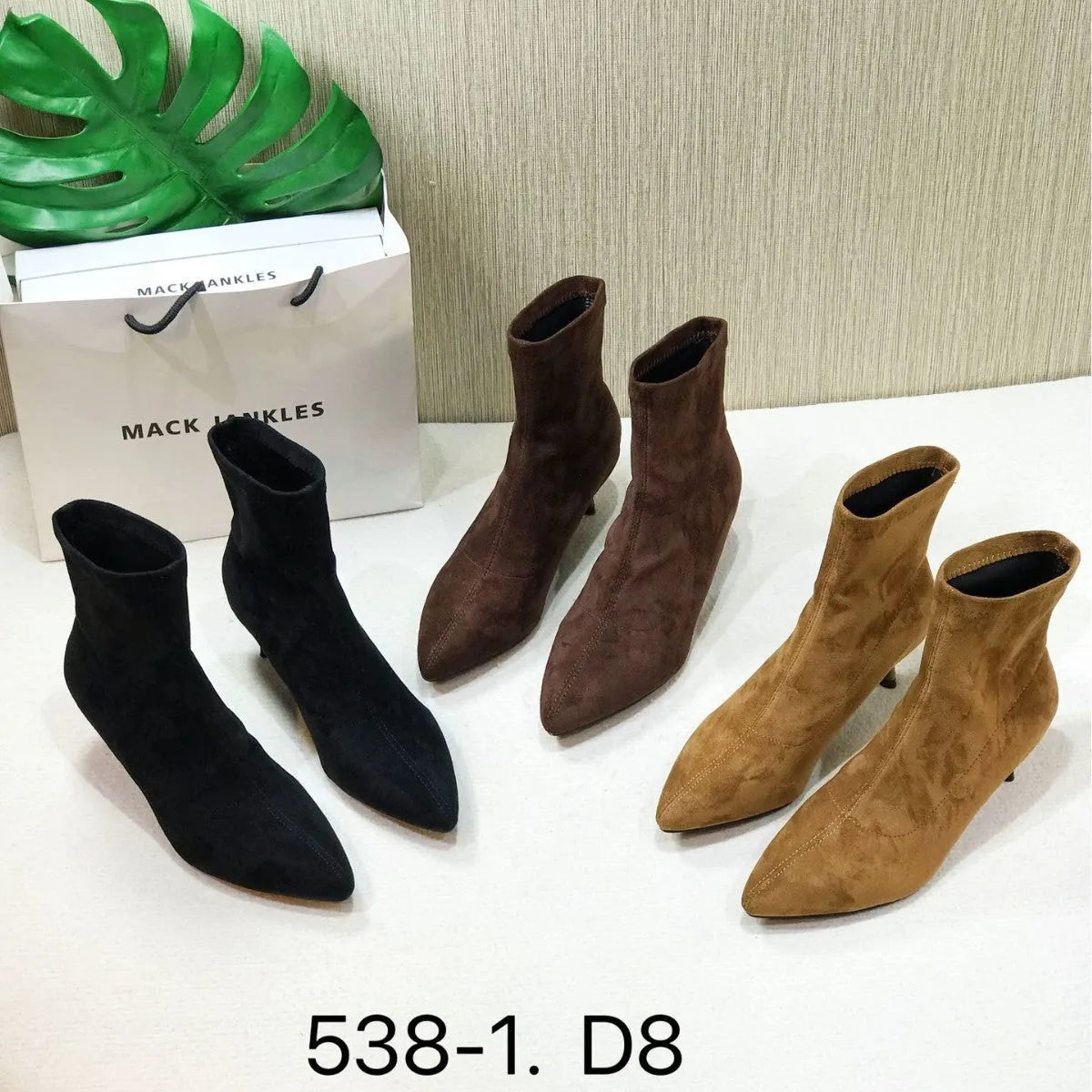 Women's black pointed toe ankle boots with a stiletto heel on a rubber sole.