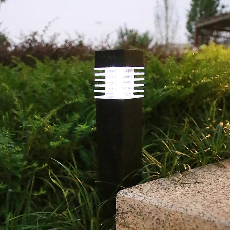 White cuboid solar lawn ground lamp for outdoor garden lighting.