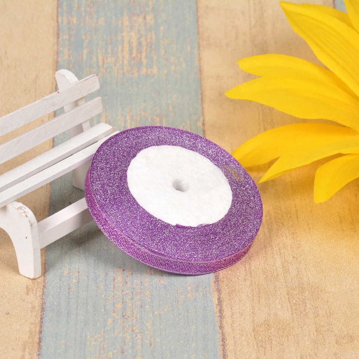 A roll of colourful green onion pattern polyester ribbon with metallic wire highlights, shown at 3-points width.