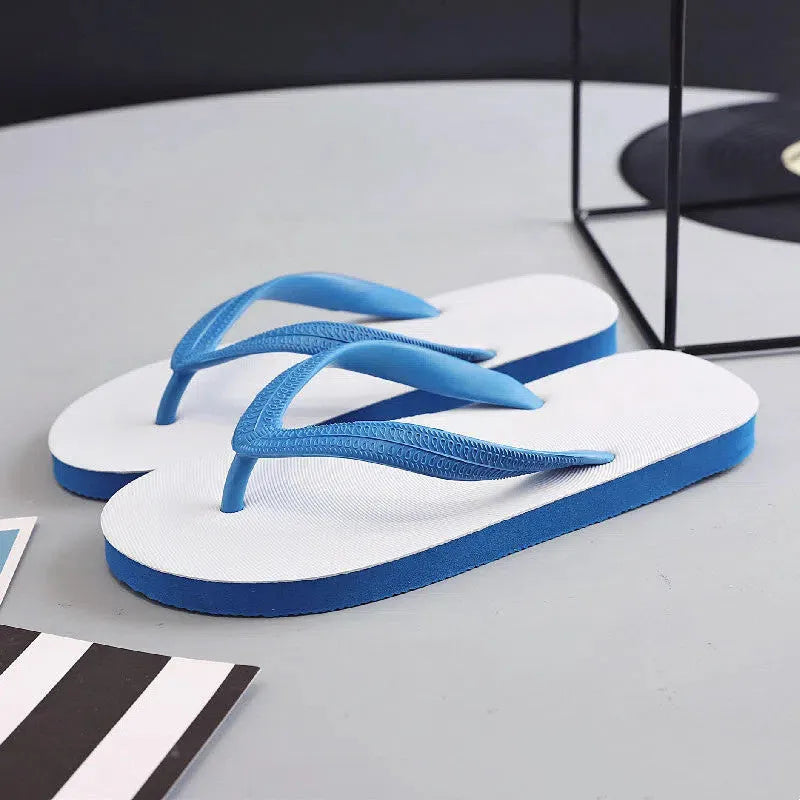 A pair of rubber flip-flops with a fish label on the strap, showcasing a non-slip patterned sole.