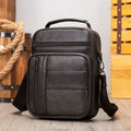 Men's black genuine leather retro shoulder bag shown from the front, showcasing its vertical square shape and zip closure.