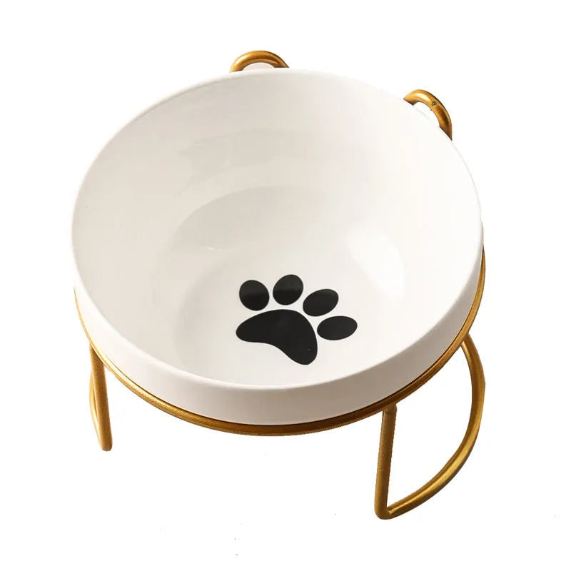 White ceramic cat bowl with paw print design in a black iron cat-ear frame.