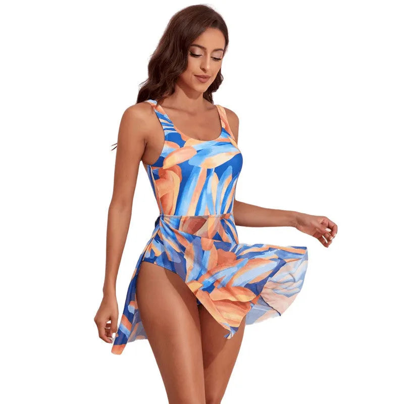 Women's single-shoulder one-piece swimsuit with digital print of leaves pattern.