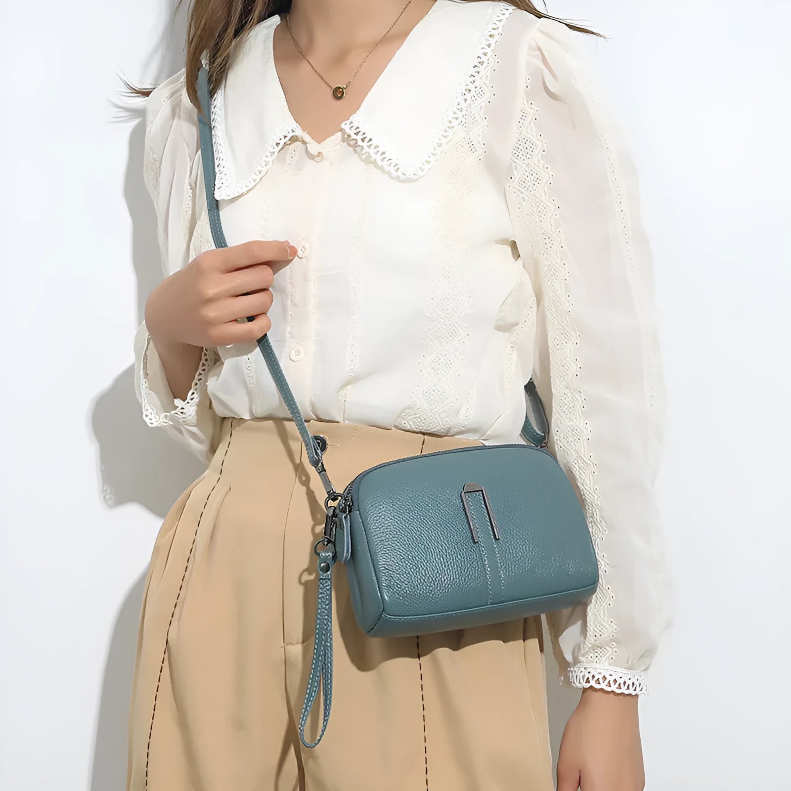Genuine cowhide leather women's shoulder bag with horizontal square shape in dark green colour.