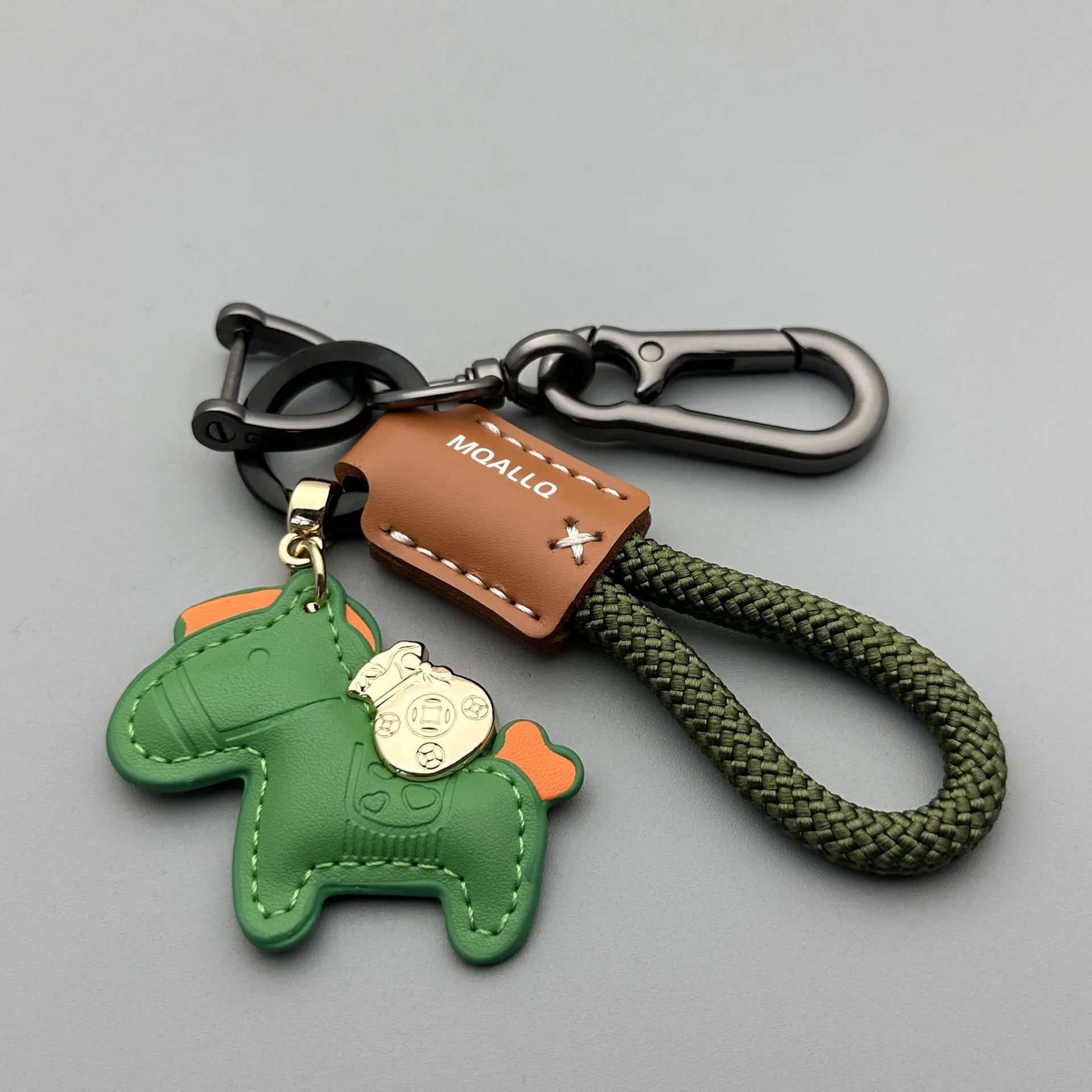 Handmade brown cowhide key ring pendant with a zinc alloy pony belt buckle and green flanelle rope.