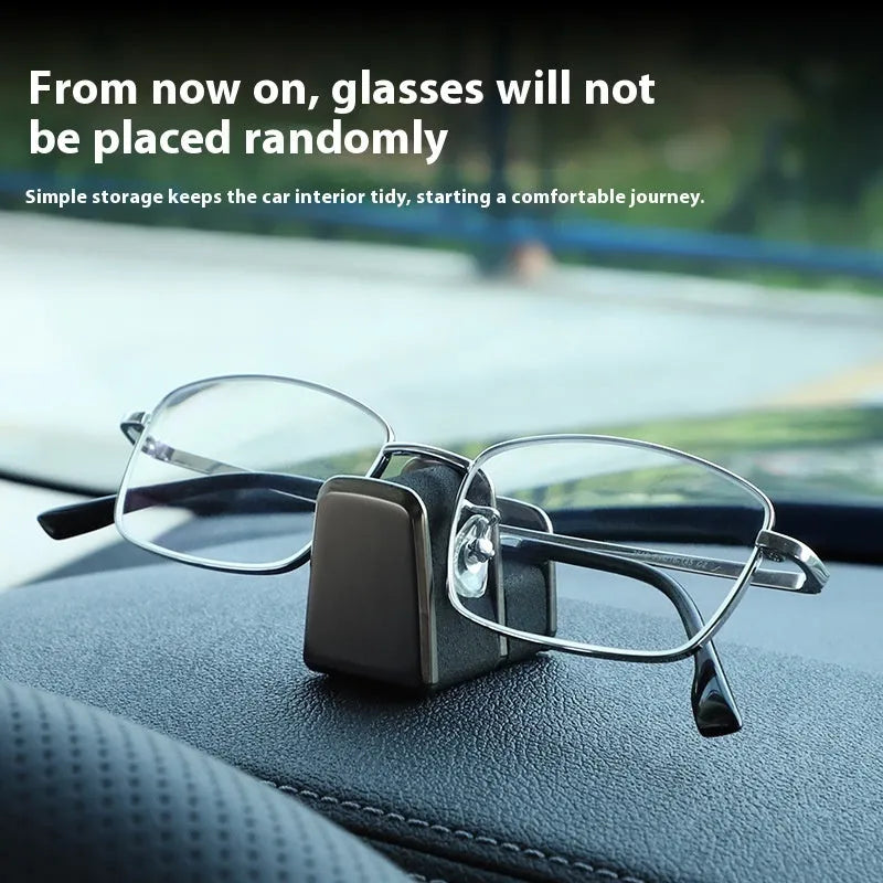 Zinc alloy and leather car dashboard clip for holding sunglasses, shown in green colour.