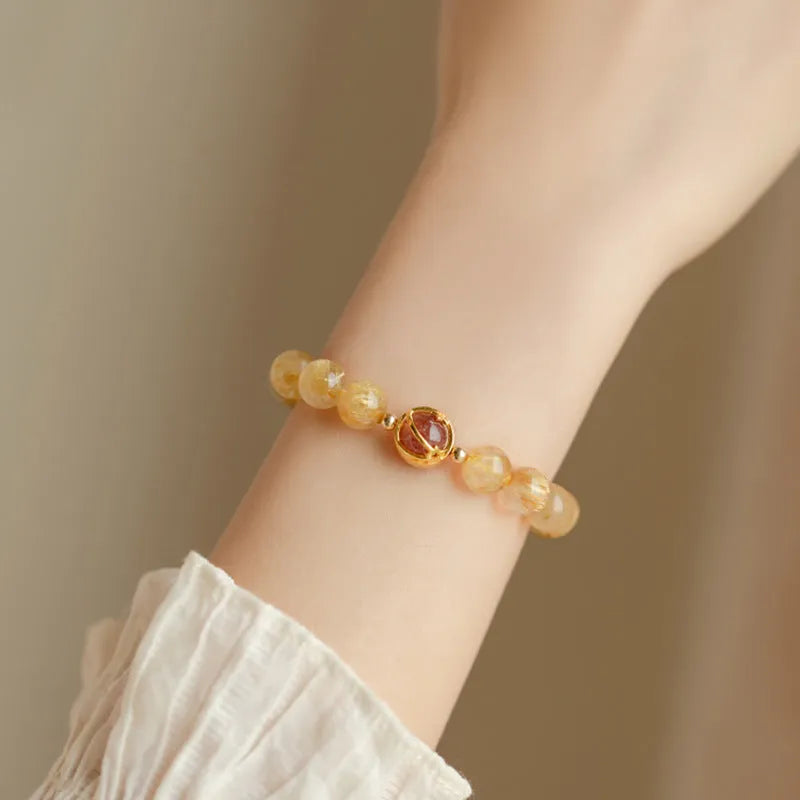 Gold rutilated quartz bracelet with diamond-cut beads in two size options