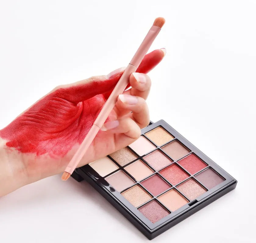 10-piece cosmetic brush set with pink wooden handles and nylon bristles arranged with makeup