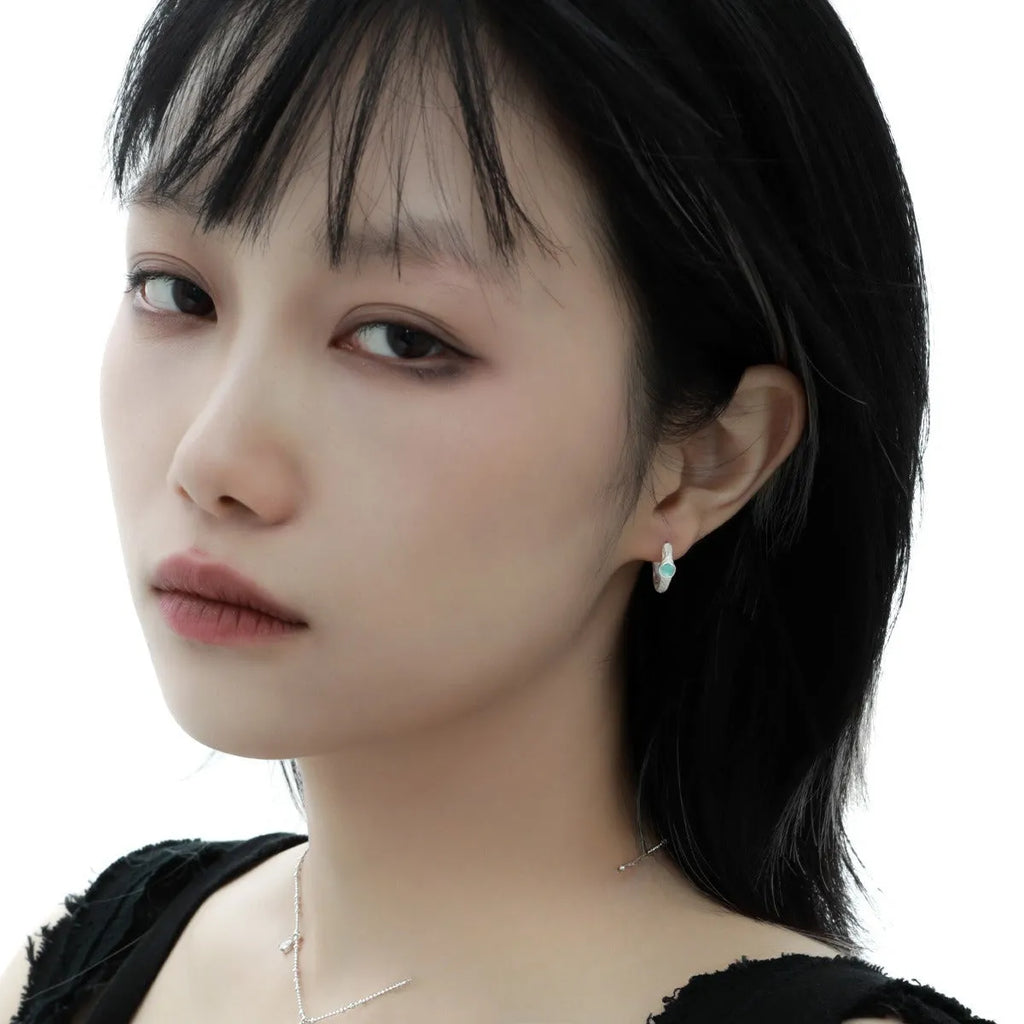 Geometric burnt silver ear clip for women made from 925 silver with round design elements.
