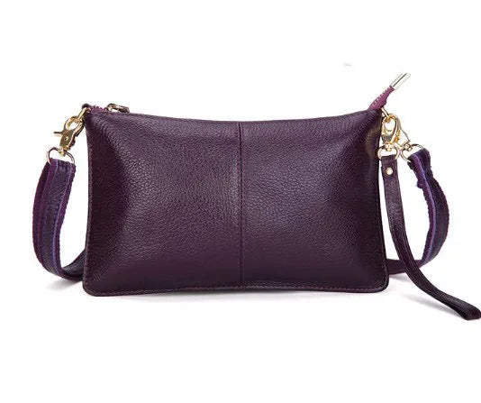 Lady cowhide slant bag showing compact design with hand strap and shoulder strap options