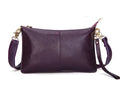 Lady cowhide slant bag showing compact design with hand strap and shoulder strap options