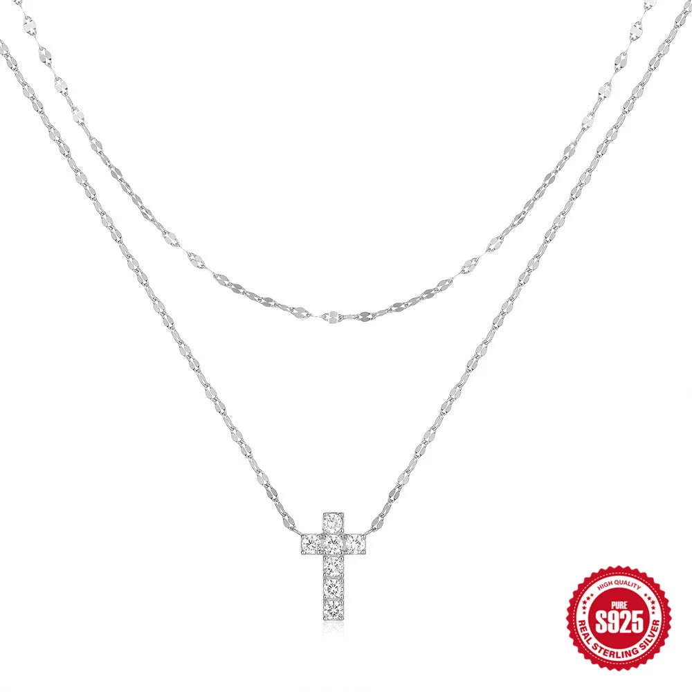 Sterling silver double layer cross pendant with twin diamonds on a clavicle chain.