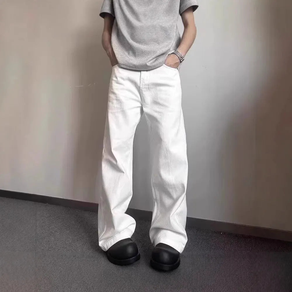 Men's loose straight leg white cotton denim jeans on a hanger.