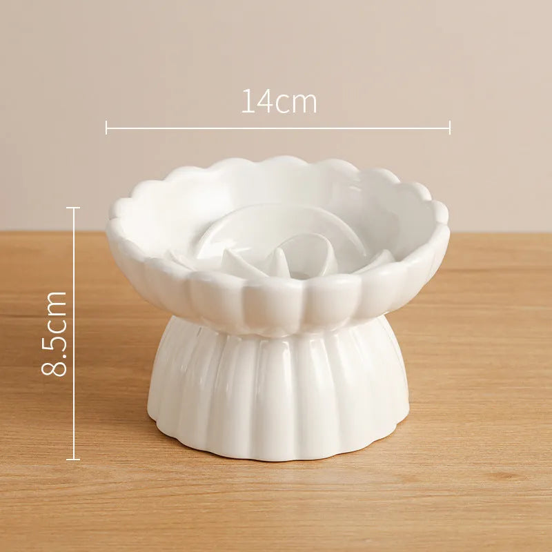 Ceramic slow feed dish with flower pool design and higher edges for cats and small dogs, shown in pink.
