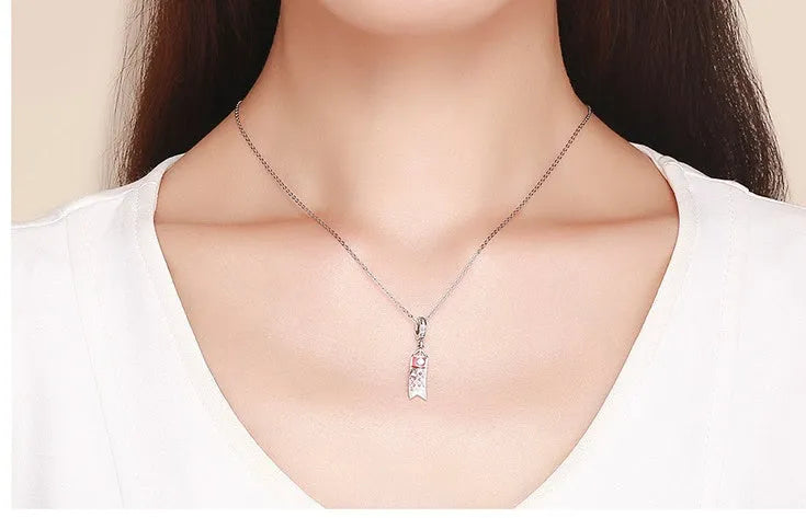 S925 sterling silver carp streamer pendant necklace with zircon detailing on a dark background.