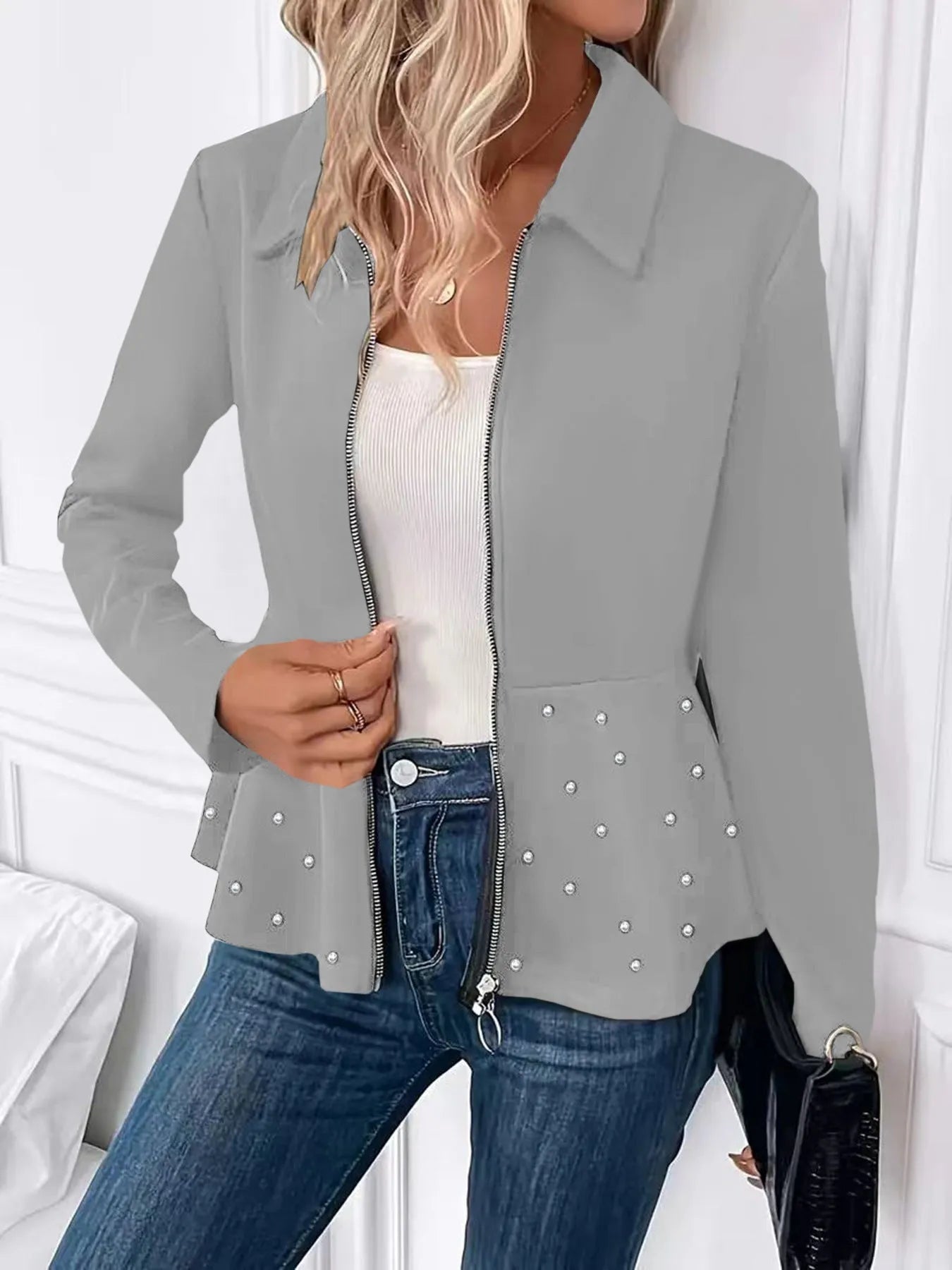 Women's black loose fit coat with a ruffled hem and a heavy-duty front zipper.
