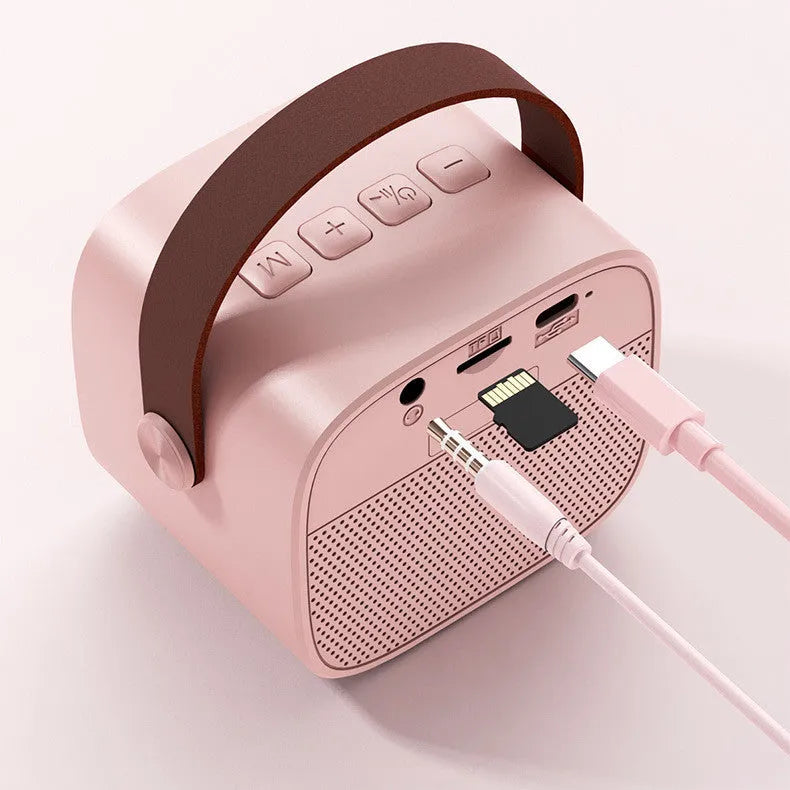 Compact blue wireless Bluetooth portable speaker with built-in microphone on a table.