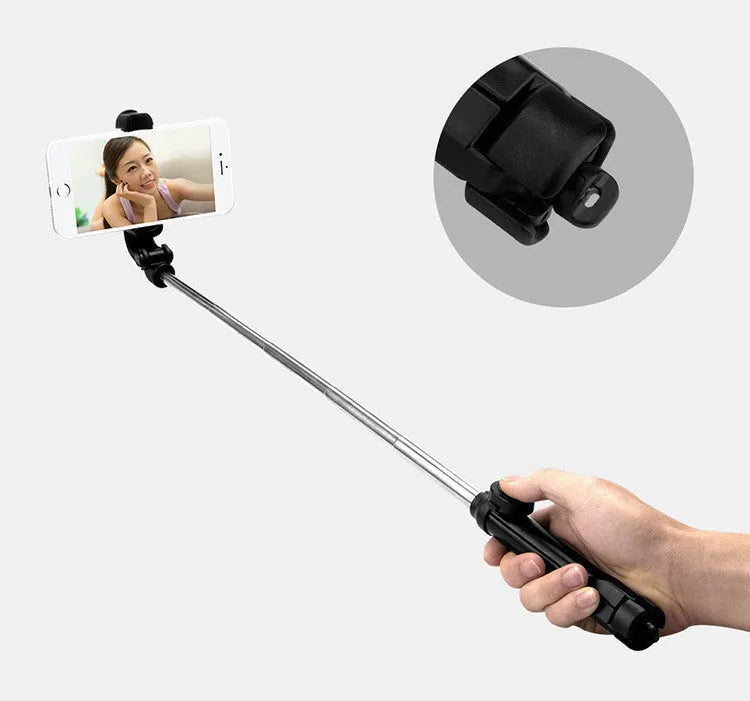 Bluetooth selfie stick tripod with aluminium pole extended, showing phone clip rotation and foldable legs
