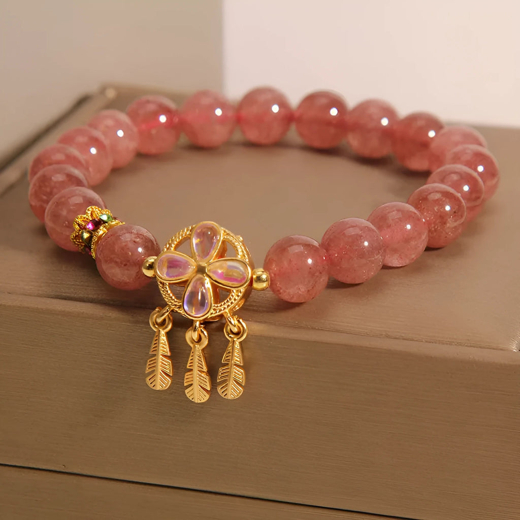Women's adjustable strawberry quartz bracelet with four leaf dream catcher ball pendant and crystal beads