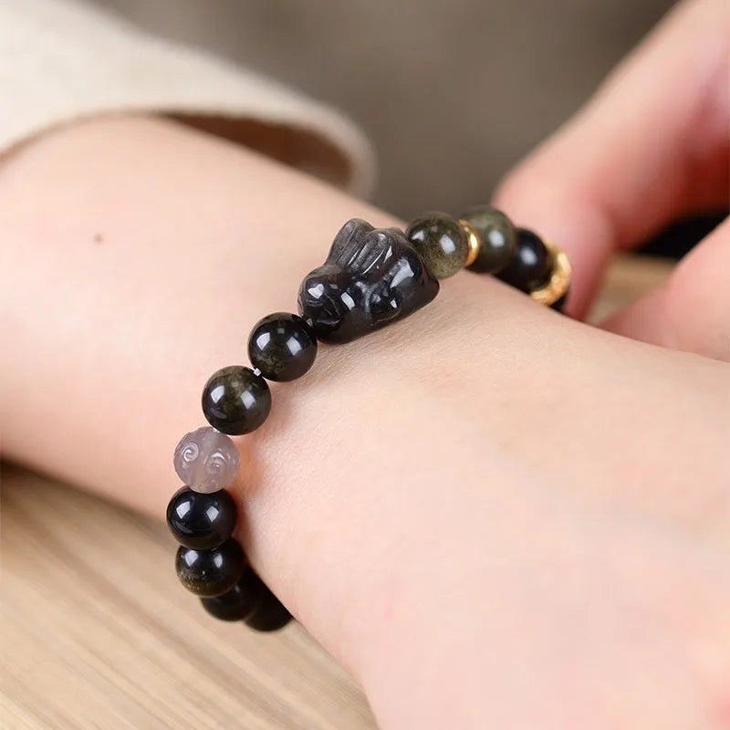 Handmade lying rabbit obsidian bracelet with Jin Yaoshi and brass beads, available in 8mm and 10mm sizes.