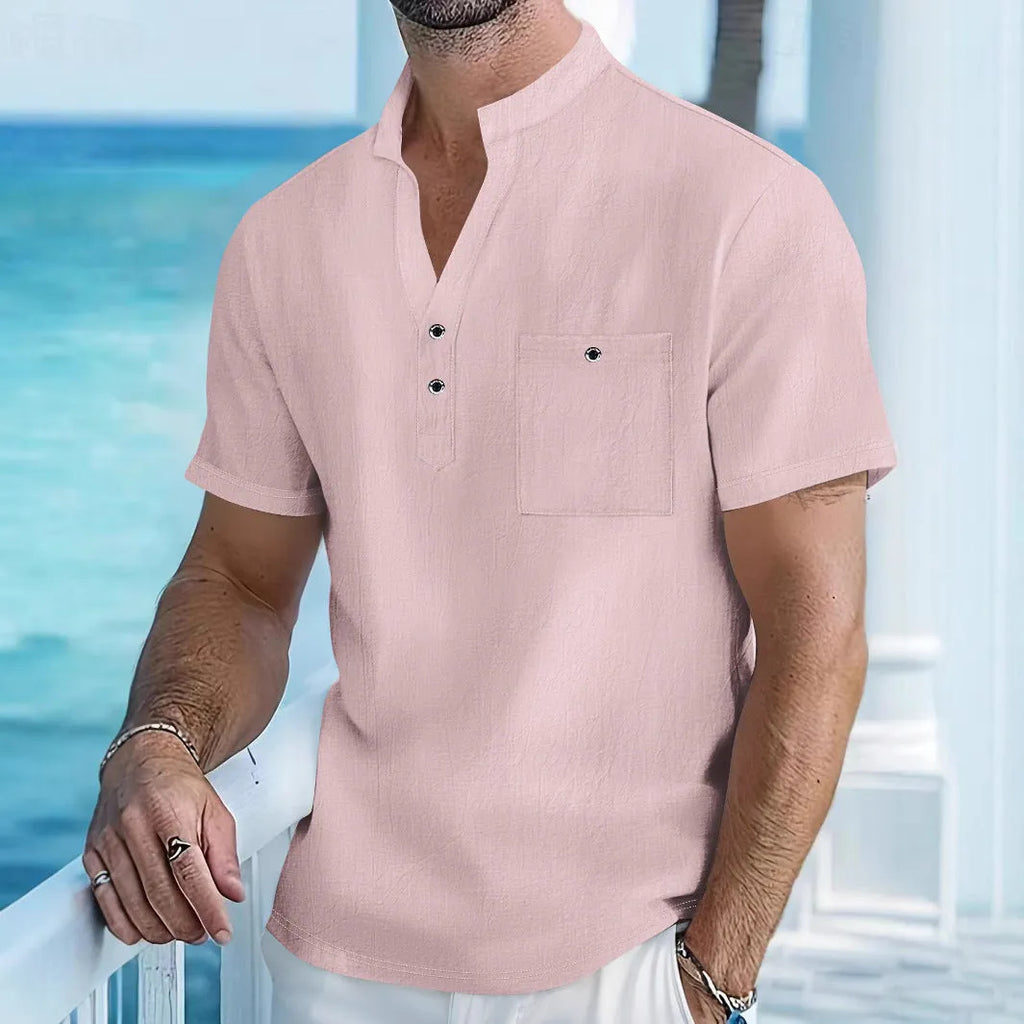 Man wearing a light-coloured linen stand collar short sleeve shirt in a loose fit.