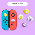 Set of four silicone cat claw key caps for Nintendo Switch Lite joysticks in assorted colours.