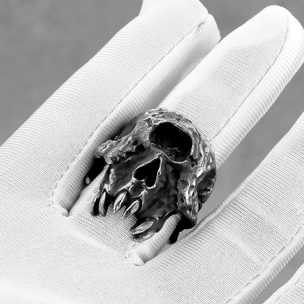 Silver-coloured alloy ring with a detailed one-eyed skull design on a finger.