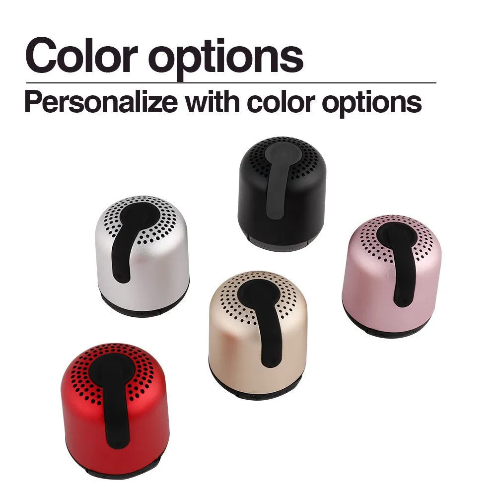 Hieha XQ11 cylinder-shaped portable Bluetooth speaker in silver colour on a table.