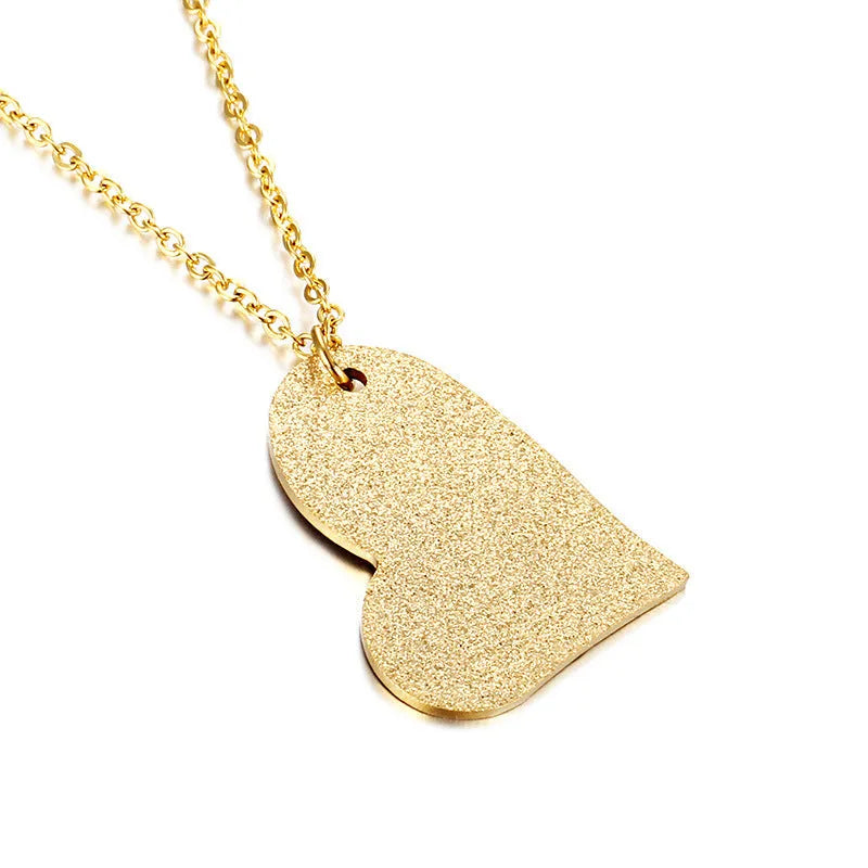 Close-up of a women's geometric heart-shaped titanium steel pendant necklace on a chain.