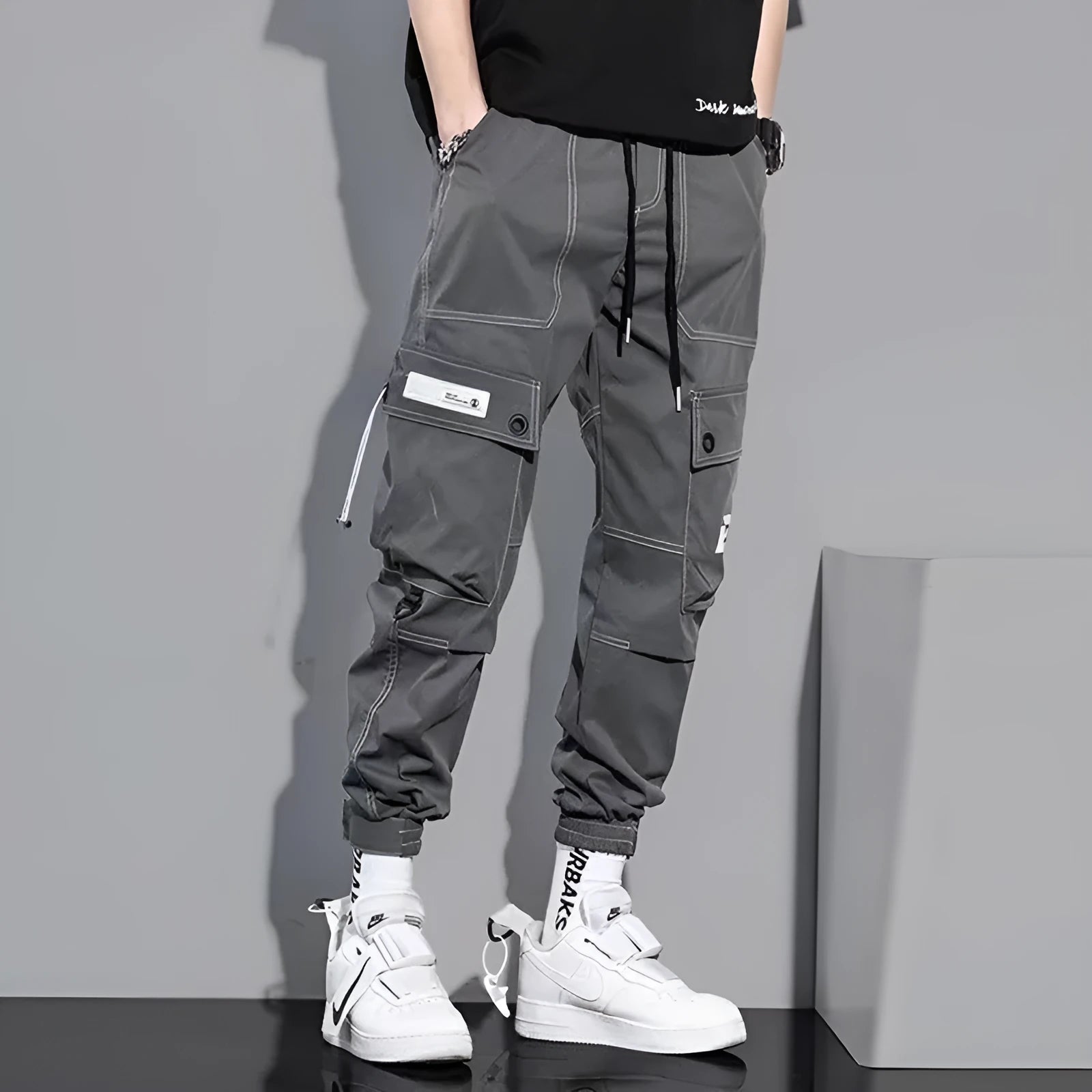 Men's loose fit solid colour polyester trousers in gray, front view, for casual autumn wear
