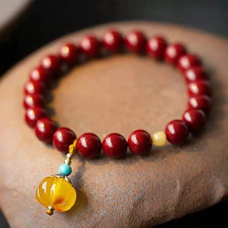 Handcrafted gold cinnabar bracelet with wave design in pumpkin cinnabar colour