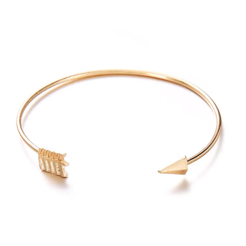 Gold-coloured women's vintage cuff bracelet with arrow and knot design in electroplated alloy