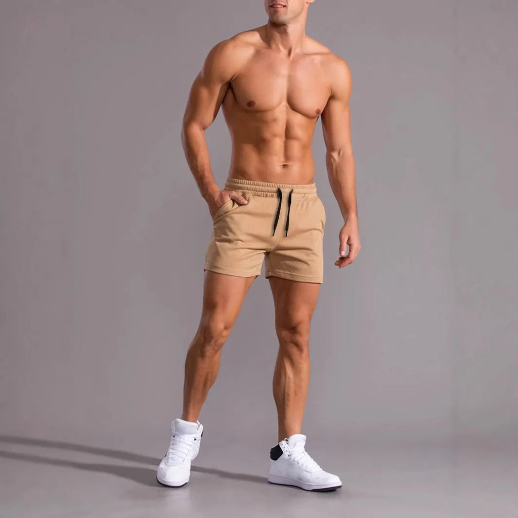 Pack of three men's solid colour drawstring shorts in loose fit on a plain background.