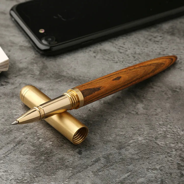 Brass sandalwood signature pen 14cm with wood barrel on a flat surface