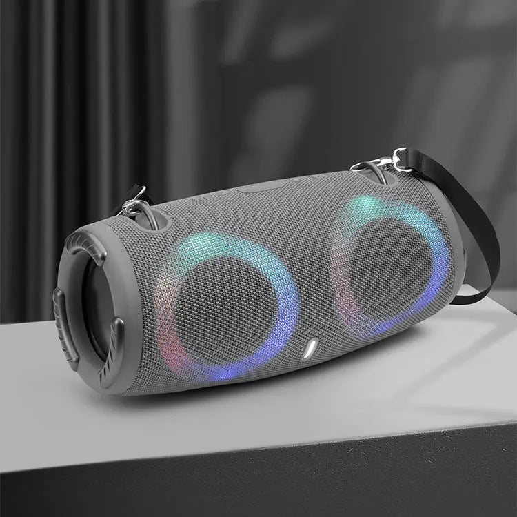 War Drum portable Bluetooth speaker with RGB coloured lights in black, showing built-in strap and control buttons.