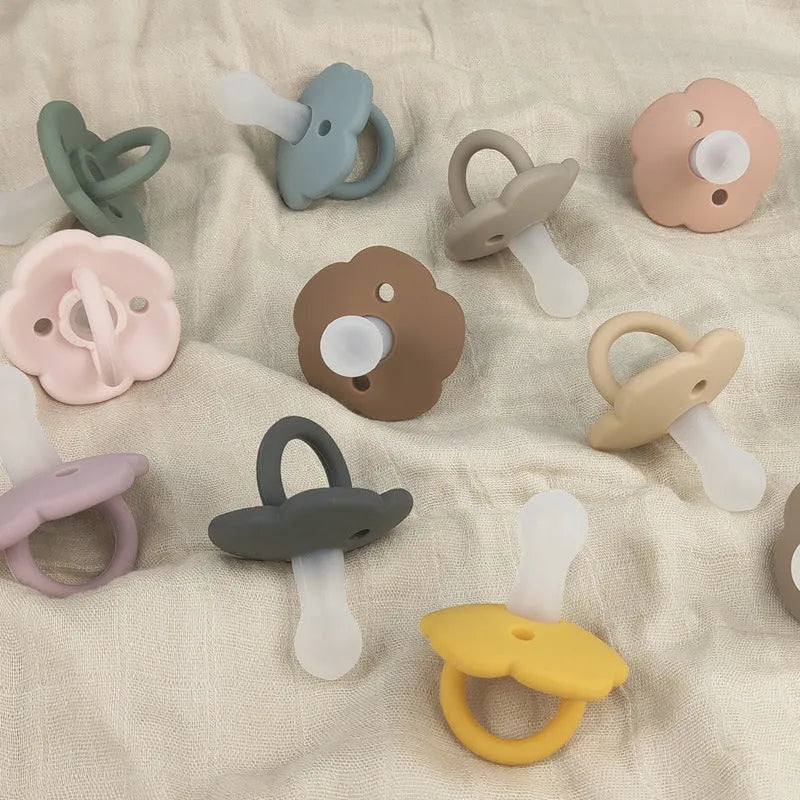 Baby pacifier with silicone lace nipple in 6.5x5x5cm size available in 11 colours for 0-6 months