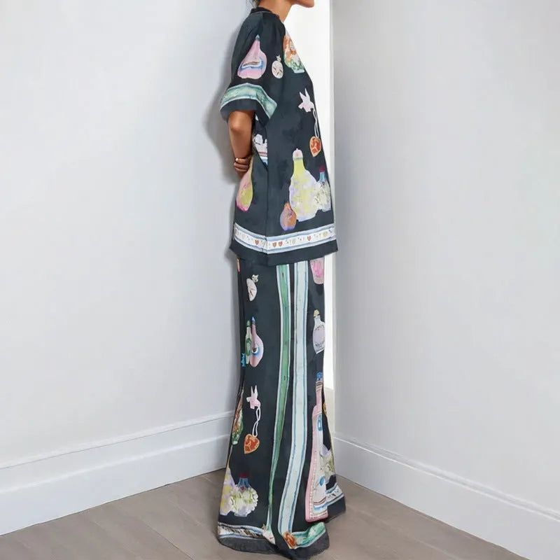 Black women's casual set with anime cartoon print, featuring a long sleeve cardigan and matching trousers.