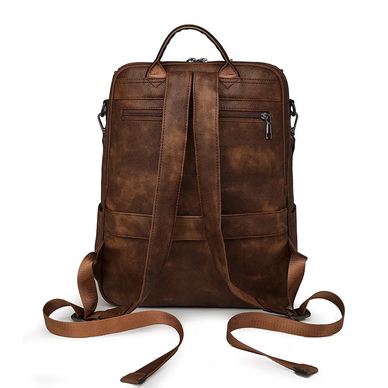 Retro college style PU backpack with curved shoulder straps shown in a solid colour with stitching detail.