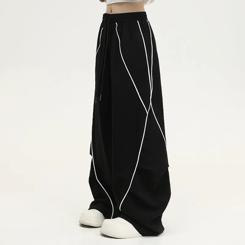 Black pleated wide-leg hip hop trousers with stripes, loose fit for sports.