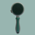 Green and pink dual-sided pet brush with slicker pins on one side and silicone massage pins on the other