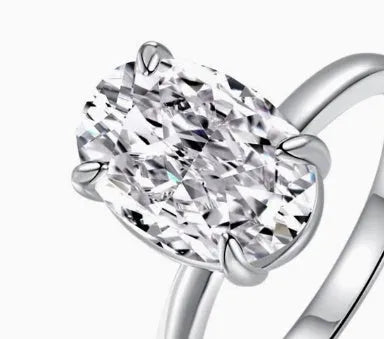 Gold or silver oval women's ring with a four-claw setting holding a hand-cut stone.