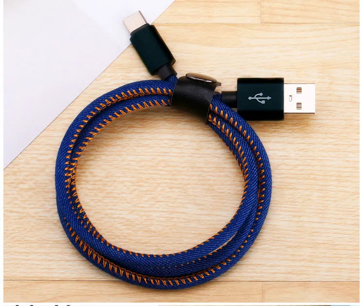 Cowboy-style denim USB-C charging cable with aluminium connectors in black, blue, or red.