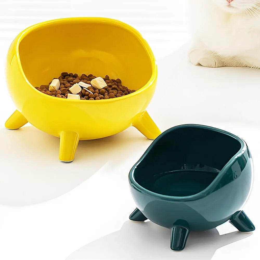 Green ceramic pet bowl with four legs and rounded splatter guard for cats and small dogs