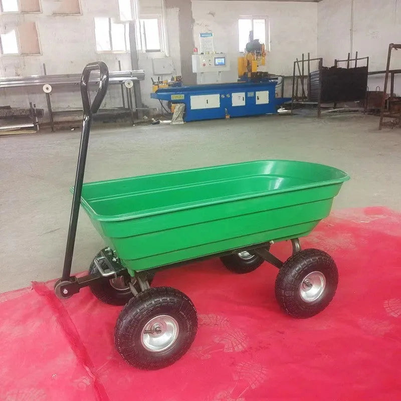 Green TC2145 four-wheel toy dump truck with steel frame and plastic body in a garden setting.
