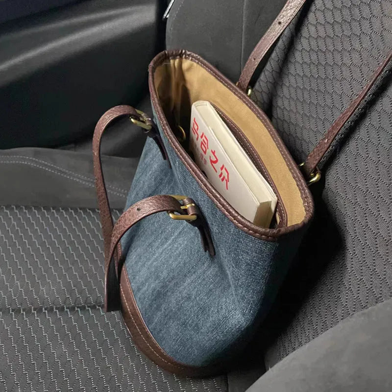 Denim patchwork bucket handbag showing patchwork detailing and one-shoulder strap