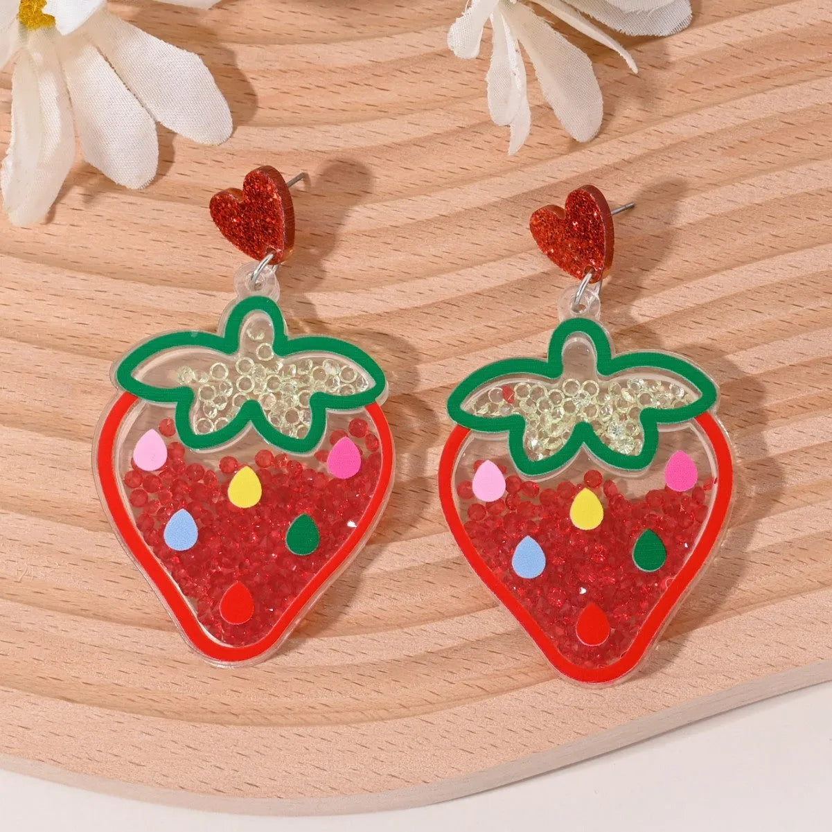 Colourful acrylic stud earrings with cherry, strawberry, watermelon, pineapple, coconut, cake, and ice cream designs.